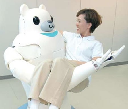 A large white humanoid robot with the head of a teddy bear carrying a patient in its long arms