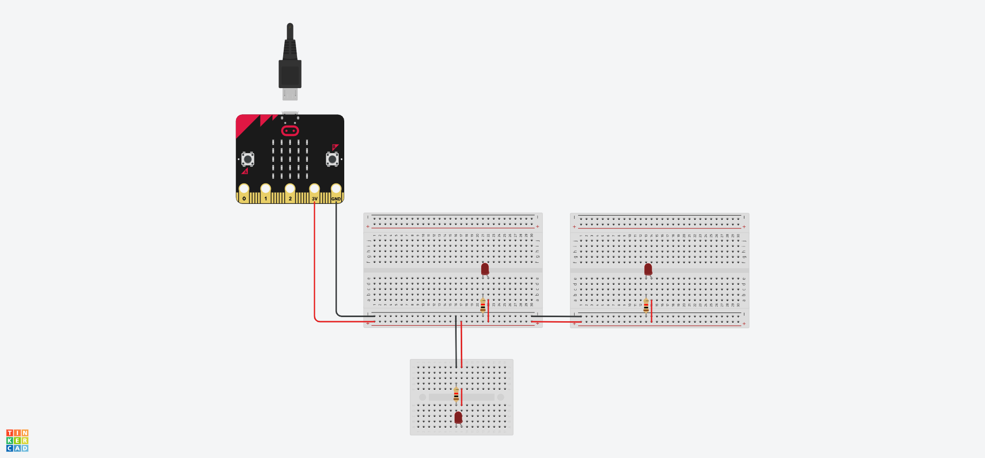 A Tinkercad circuit showing a BBC Micro:Bit connected to a breadboard, which in turn, is connected to another breadboard and a mini breadboard. Each board has a red LED and associated resitor attached.