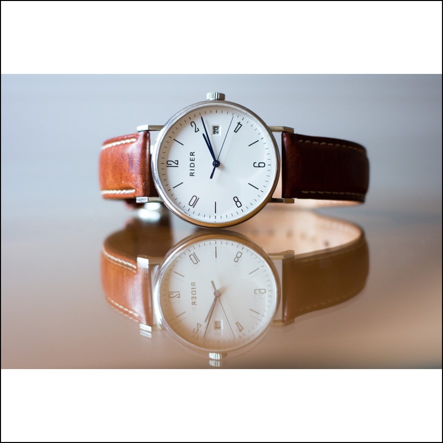 A leather strapped basic analogue wristwatch