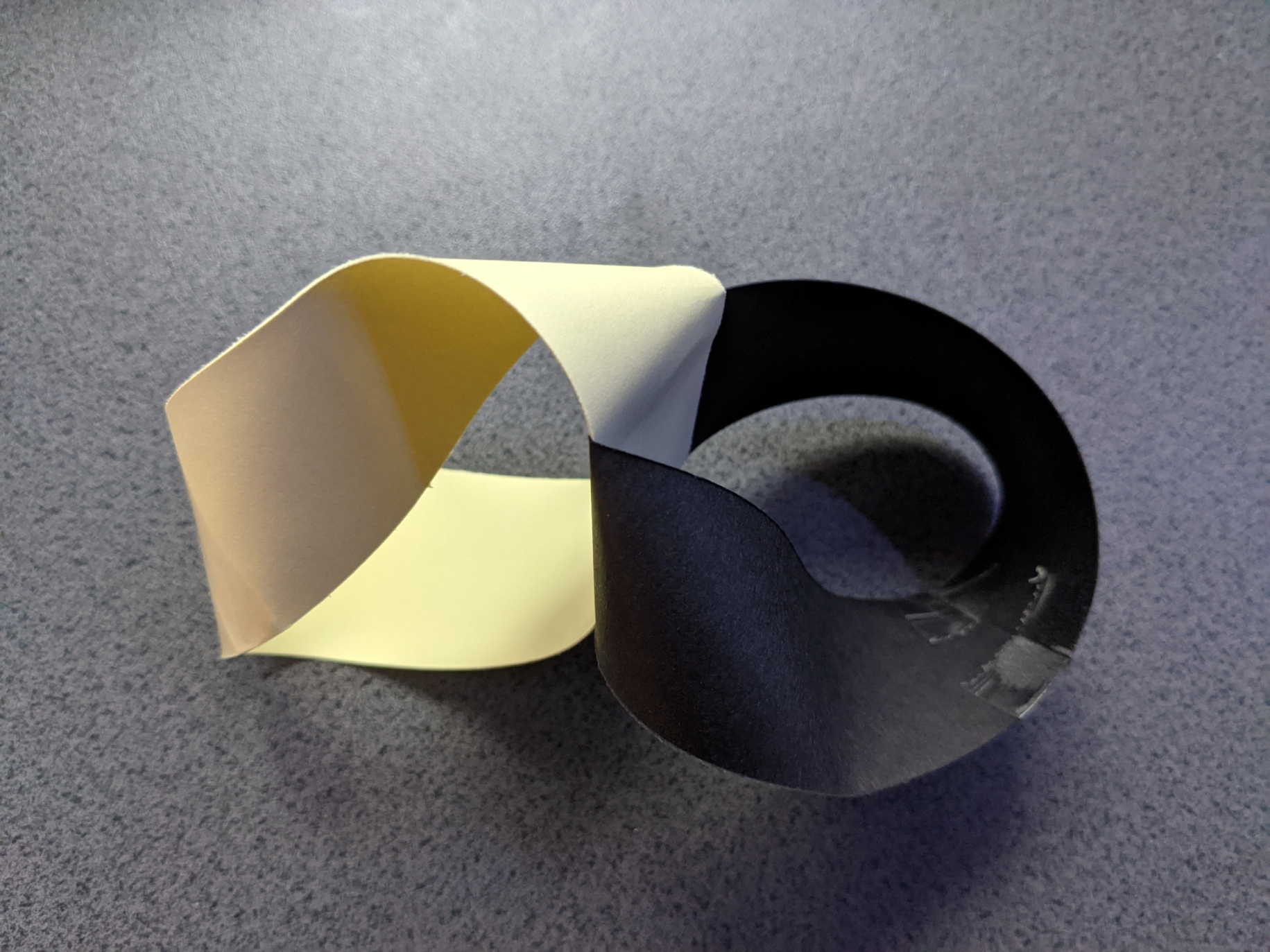 Two Möbius Strips of identical length and opposite twist directions attached at right angles to each other.